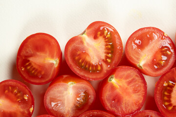 Small ripe tomatoes cut into halves macro top view
