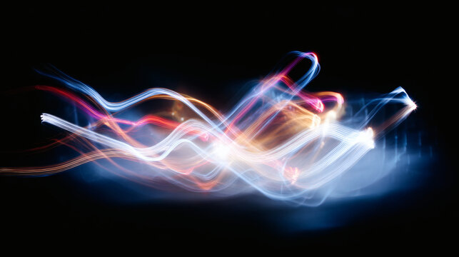 Vibrant light trails dance across a dark canvas, showcasing abstract motion and energy.