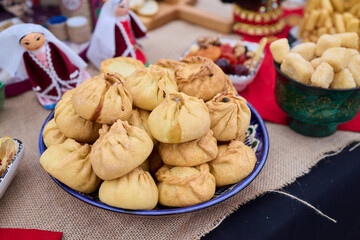 Savor the Delicious Golden Dumplings uchpochmak Beautifully Served on a Colorful and Inviting Table