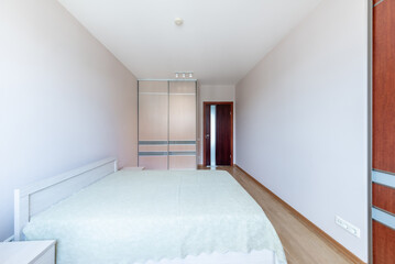 Modern Minimalist Bedroom Interior with Wooden Furniture and Wardrobe