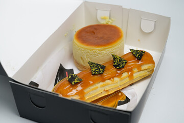 delicious pastries highlighting eclair and cheesecake on white background