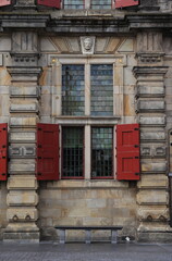 Delft City Hall Building Exterior Detail with Window and Red Wooden Shutters, Netherlands
