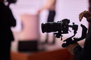 Closeup image showing someone gripping a DSLR camera with an articulated screen