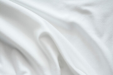The texture of the bright white fabric is wavy and flowing, the wrinkles of the white stretch...