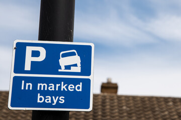 Blue parking sign with a white 
