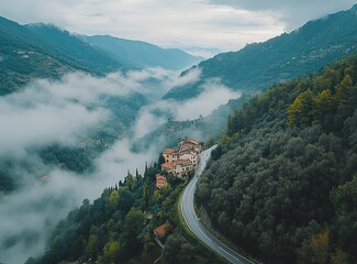 Beautiful, winding asphalt road in the green forest with mountains and clouds in the background, northern Italy. A scenic highway for car travel through the natural landscape of the Alps. Restaurant C
