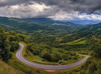 Beautiful, winding asphalt road in the mountains, with a green forest and meadow in the background. Summertime. Beautiful natural landscape of northern Italy. Panorama. Stock photo contest winner, pho