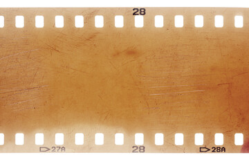 Dusty and grungy 35mm film texture or surface. Perforated scratched camera film isolated on white background.