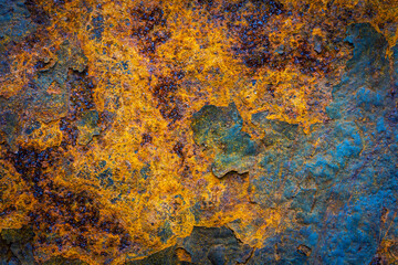 Rusty metal surface with shabby background paint. Blue cracked paint texture on an iron sheet. Fragment of an old metal door, Metal corrosion.