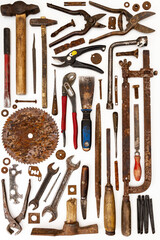 Flat lay of old hand tools on white background. Large collection of various rusty tools and bits arranged on white.