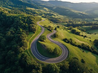 Beautiful, winding asphalt road in the mountains, with a green forest and meadow in the background. Summertime. Beautiful natural landscape of northern Italy. Panorama. Stock photo contest winner, pho