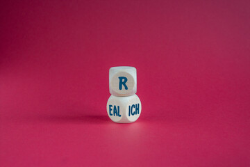 Cubes form the words 'Real rich'. Beautiful red background. Real rich and business concept.