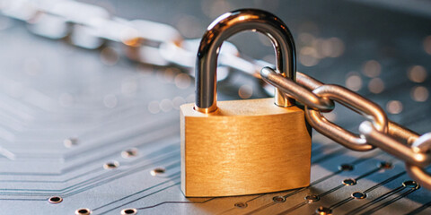 Abstract background in technology. Close-up of a padlock on a circuit board in the concept of...