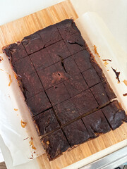Freshly baked brownies cut into pieces.