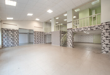 Spacious Vacant Commercial Interior With Loft and Stairs, Decorated With Floral Patterns