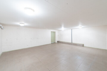Spacious Empty Room with Plain Walls and Tiled Flooring