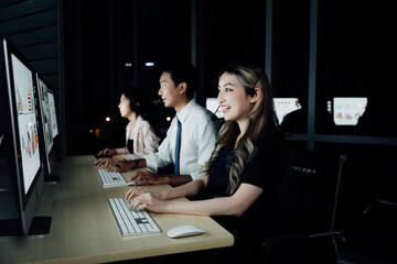 Female support agent in modern trading room using headset, assisting traders during real-time stock...