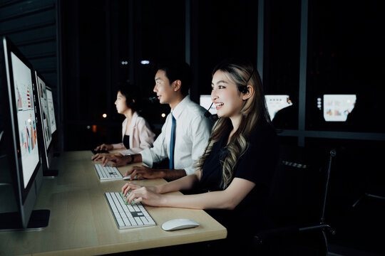 Female support agent in modern trading room using headset, assisting traders during real-time stock market sessions. Highlights finance tech and human support in trading.