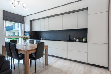 Modern Kitchen Interior with Wooden Dining Table and Leather Chairs