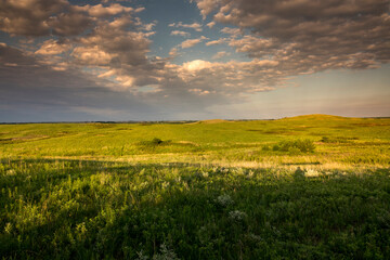 This warm sunset on the grassy, tallgrass prairie of Kansas and the Maxwell Wilflife Refuge illustrates the quiet and spaciousness of the  open prairie.