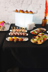 Assorted canapes on metal trays. Delicious appetizers for a buffet.