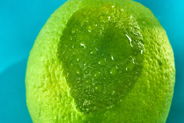 Fresh lime is prominently featured, showing its textured peel and glistening water droplets.