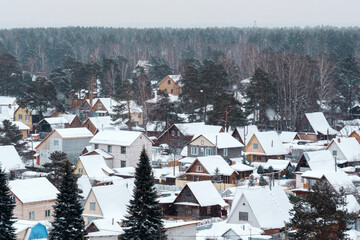 Snow blankets a tranquil village as winter takes hold in a serene landscape filled with charming homes
