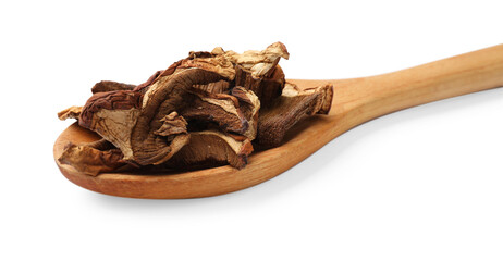 Pieces of dried mushrooms and spoon isolated on white