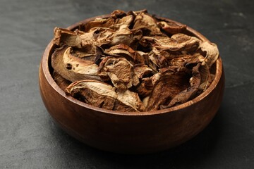 Dried chanterelle mushrooms on wooden table, closeup