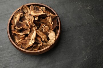 Dried chanterelle mushrooms on wooden table, top view. Space for text
