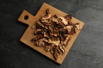 Dried chanterelle mushrooms on wooden table, top view