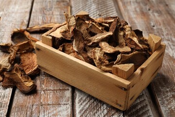 Dried chanterelle mushrooms on wooden table, closeup