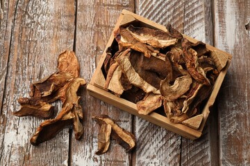 Dried chanterelle mushrooms on wooden table, flat lay