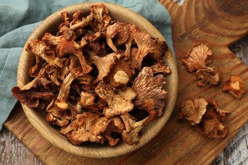 Dried chanterelle mushrooms on wooden table, flat lay