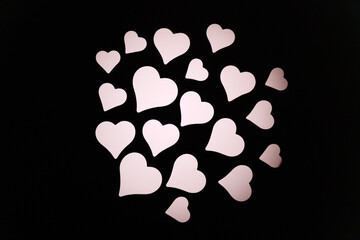 Colorful heart shapes create a vibrant display in a dark setting during a festive celebration