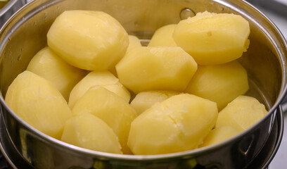 Boiled whole potatoes, without skin, in a pot