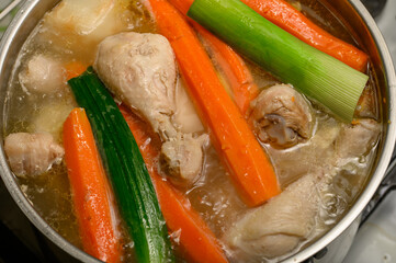 Chicken and vegetable broth simmered in a large pot, natural collagen