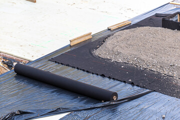 Industrial construction site with geotextile fabric roll and gravel layered foundation