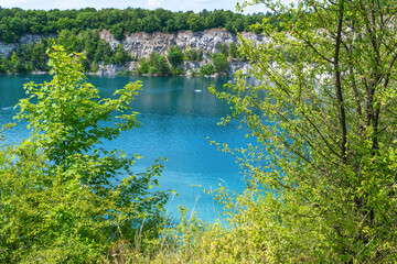 Serene landscape with lush trees surrounding a peaceful lake. Zakrzowek lagoon. Krakow