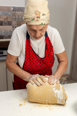 Elderly Woman Kneading Dough by Hand