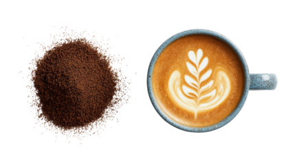 Coffee cup with latte art beside freshly ground coffee on a white background.