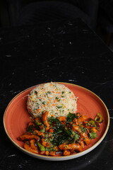 Coriander Basil with some egg fried rice on the dark background
