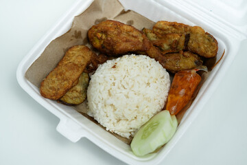 delicious ayam penyet with package in a clean isolated background