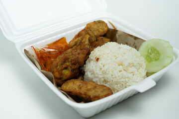 delicious ayam penyet with package in a clean isolated background