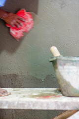 Workers plastering walls with plastic scrap