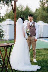wedding ceremony of a young couple in love on a green meadow