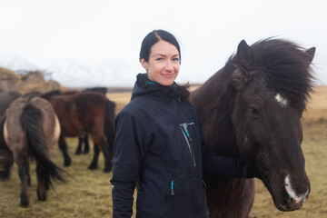 beautiful Icelandic horses with long manes near the girl