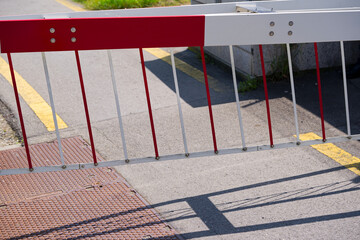 Close-up of red and white striped barrier closing at Emmen Air Base at Swiss city of Emmen on a sunny spring day. Photo taken June 12th, 2025, Emmen, Switzerland.