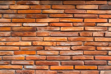 Red Brick Wall Texture: A detailed close-up shot reveals the rich texture and color variations of a weathered red brick wall, offering a rustic and appealing backdrop for design projects.