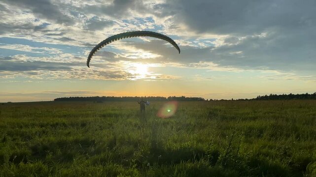 paraglider start at the sunset